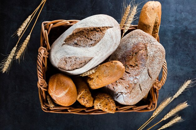 Top view of bread in a basket on black table