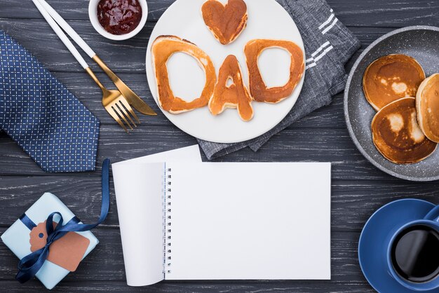Top view bread letters for father's day empty notepad