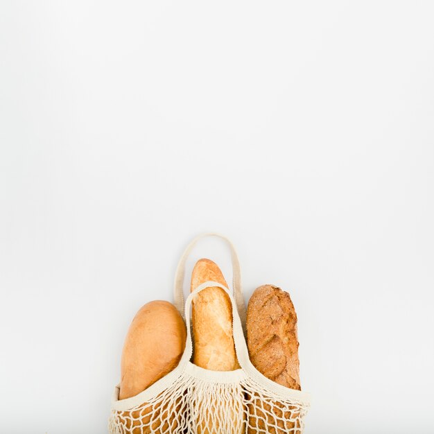 Top view of bread in reusable bag with copy space