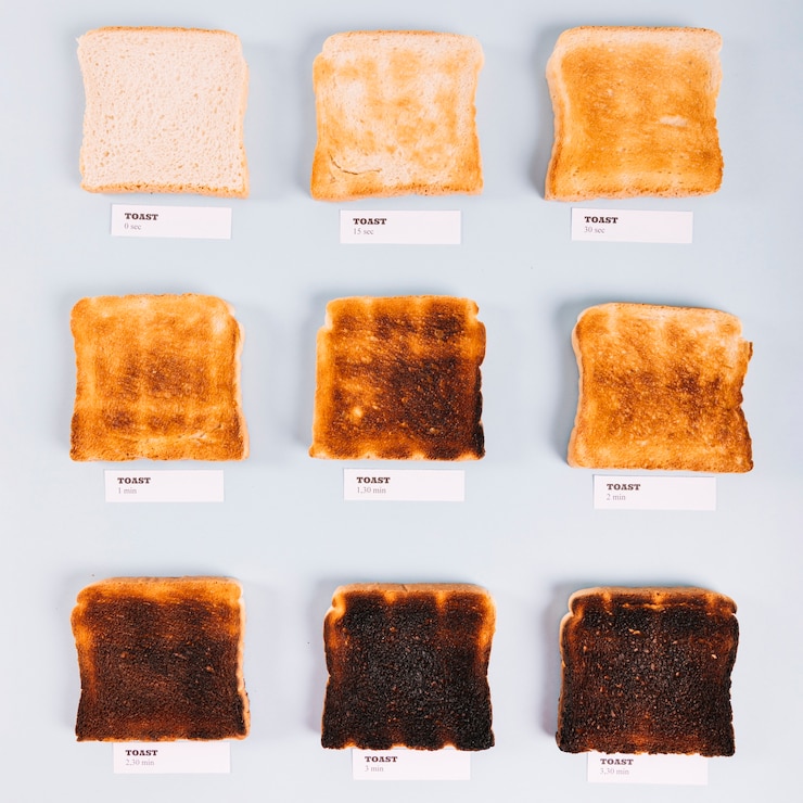 Free Photo top view of bread slices at varying stages of toasting on white background