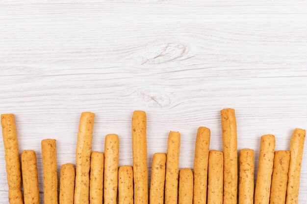 Top view bread sticks with copy space on white table