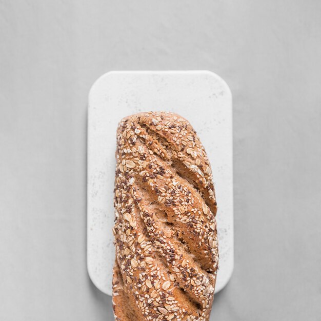 Top view bread on white cutting board