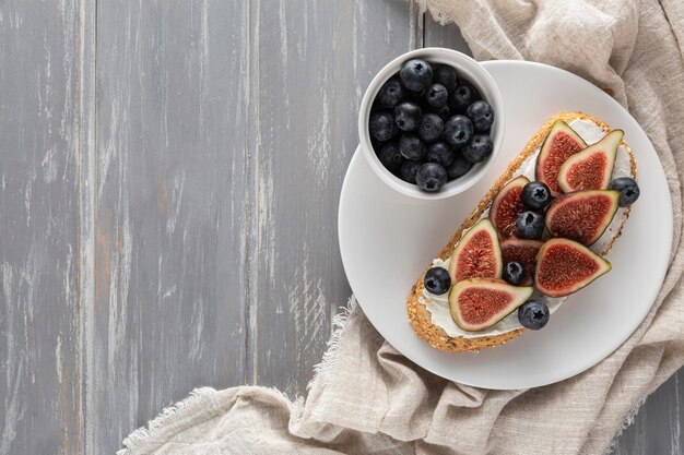 Top view bread with cream cheese and figs woth copy-space