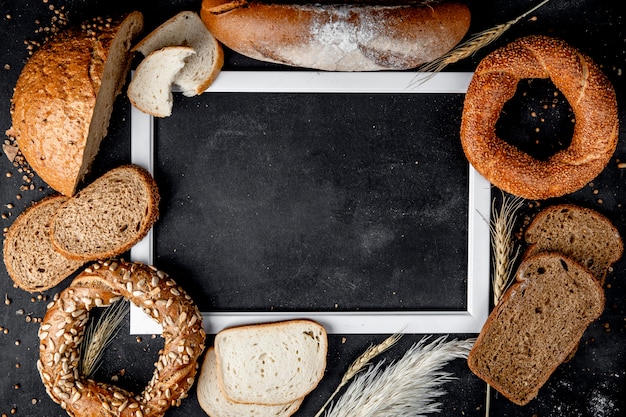 Top view of breads as baguette black bagel and others with copy space