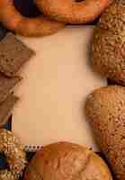 Free photo top view of breads as cob bagel and rye bread slices with copy space