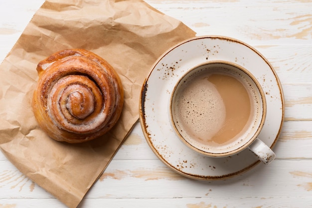 Top view breakfast assortment with coffee and pastry