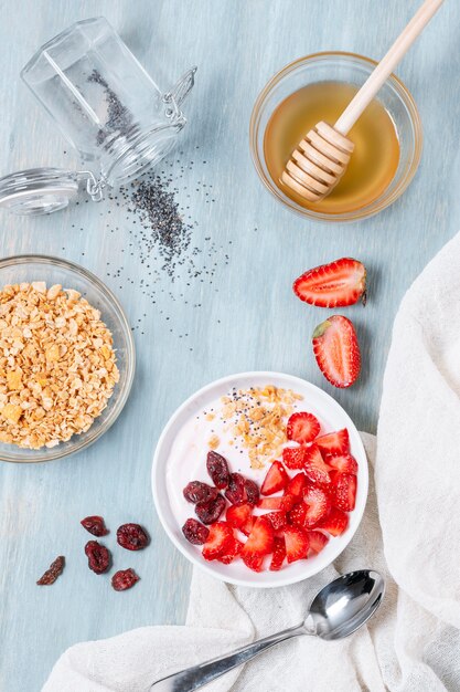 Top view breakfast bowl with honey and fruits