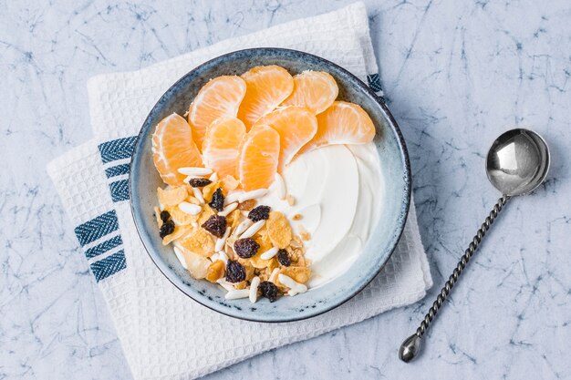 Top view breakfast bowl with orange and yogurt