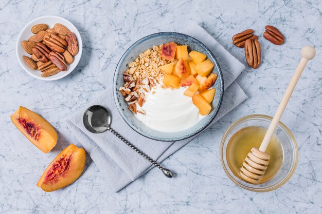 Top view breakfast bowl with yogurt and honey