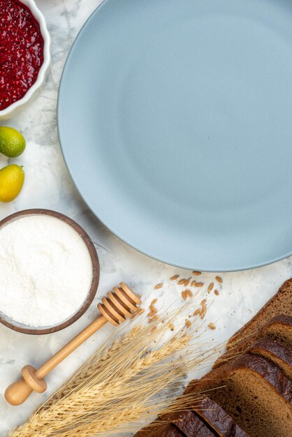 Top view breakfast table with blue plate eggs jam jelly dark bread on a white background coffee dough pie oven morning tea egg bun