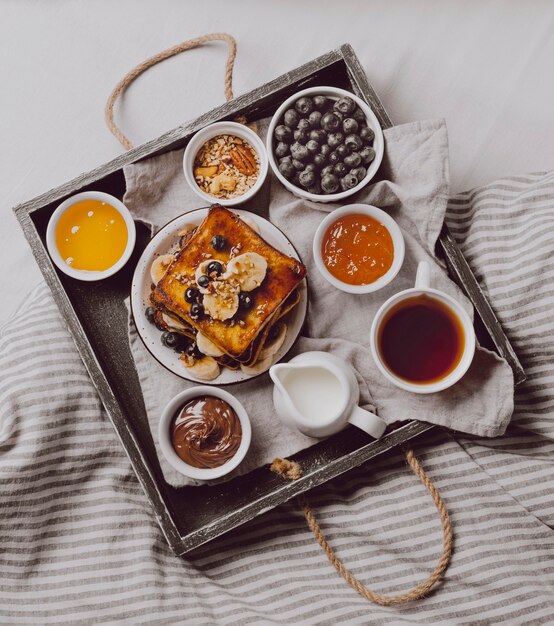 Top view of breakfast toast with banana and blueberries