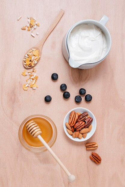 Top view breakfast with honey and yogurt