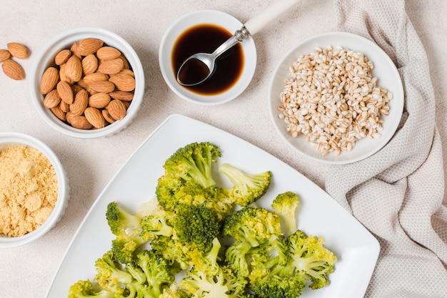 Top view of broccoli on plate with almonds