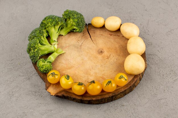 top view broccoli potatoes tomatoes fresh ripe on the brown desk on the grey floor