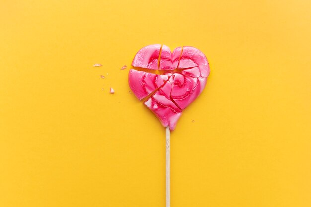 Top view of broken heart candy treat on stick