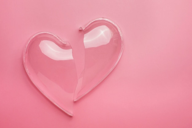 Free photo top view broken heart on pink background