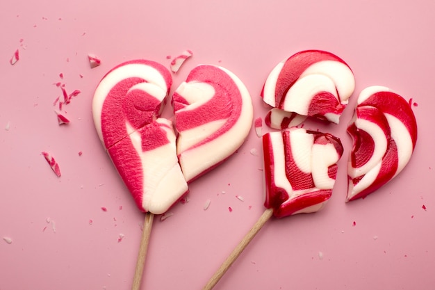 Free photo top view broken heart shaped candies arrangement