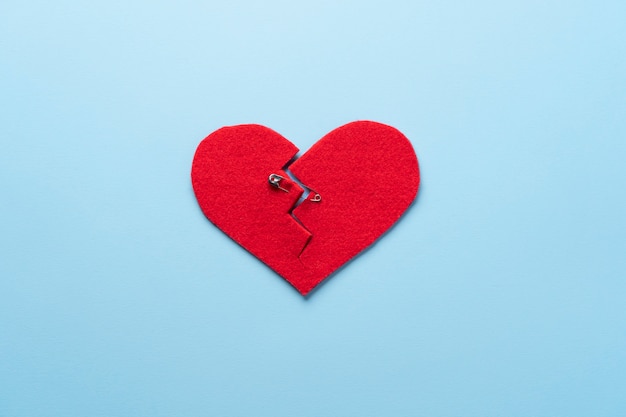 Free photo top view broken heart with safety pin