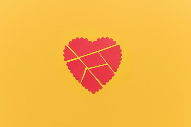 Free photo top view of broken paper heart background