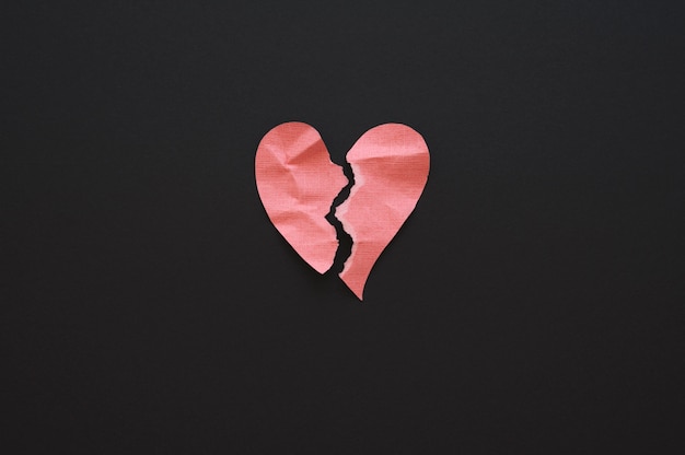 Top view of broken paper heart background