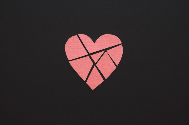 Top view of broken paper heart background