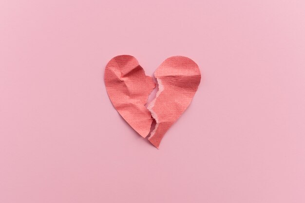 Top view of broken paper heart background