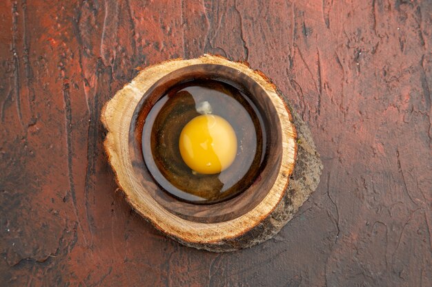 Top view broken raw egg inside plate