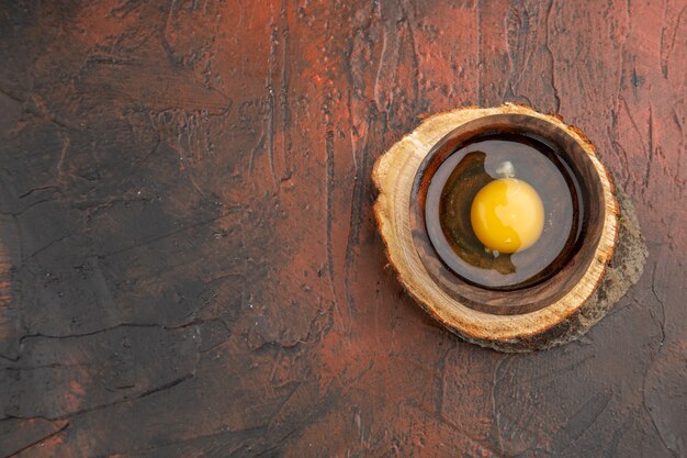 Top view broken raw egg inside plate