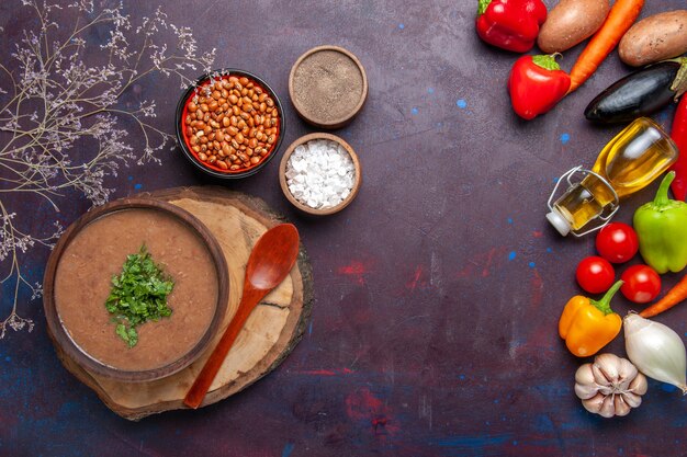 Top view brown bean soup delicious cooked soup with fresh vegetables on dark surface dinner soup bean color spicy meal