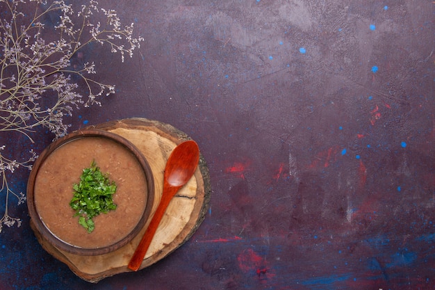 Top view brown bean soup delicious cooked soup with greens on dark background vegetable dinner soup meal food