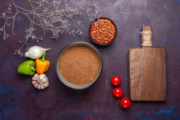 Top view brown bean soup with vegetables on dark surface vegetable soup meal food oil