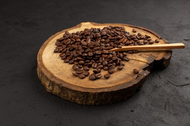 top view brown coffee seeds on the dark floor