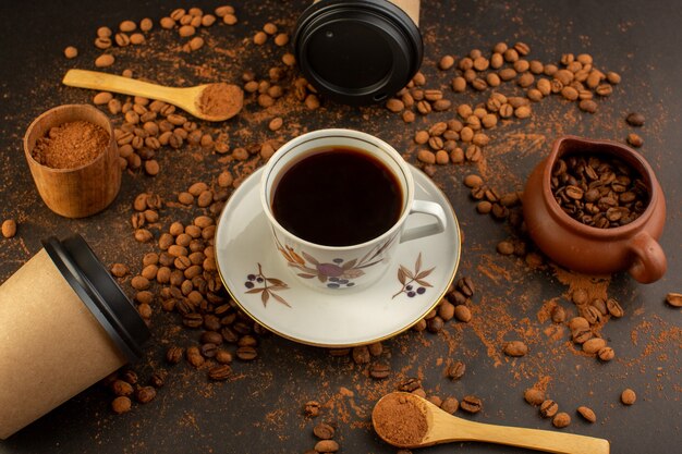 A top view brown coffee seeds with choco bars and cup of coffee