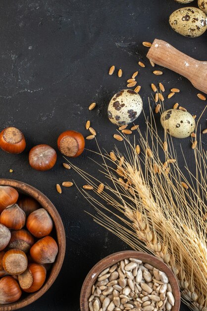 Top view of brown hazelnuts spikes eggs on dark color background with free space