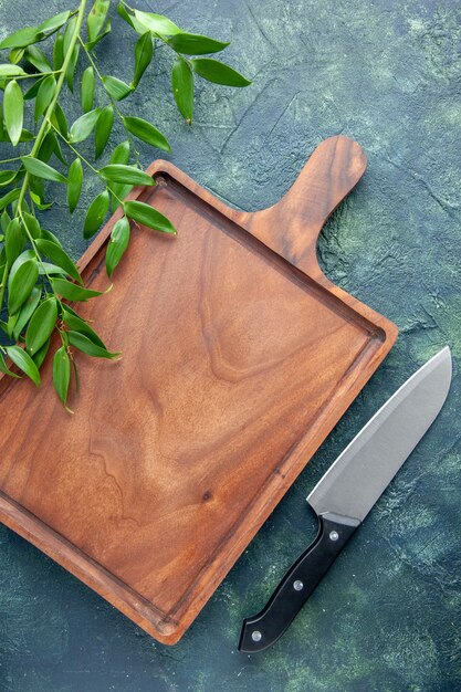 Top view brown wooden desk on a dark blue background knife food color meat kitchen ancient butcher cuisine