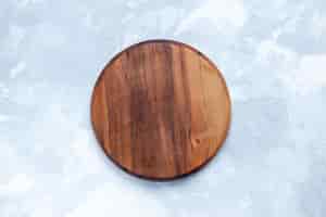 Free photo top view of brown wooden desk, round formed on light desk, wood wooden