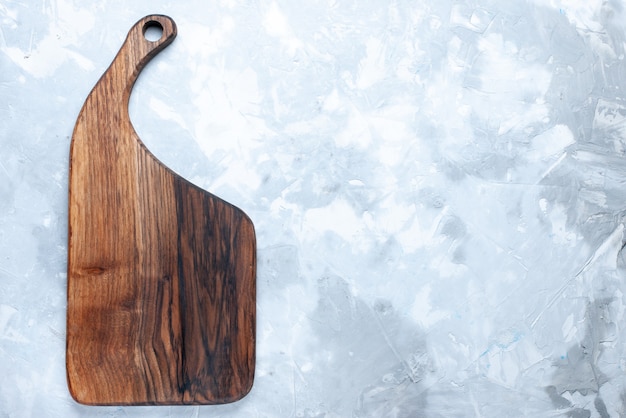 Top view of brown wooden desk, for vegetables and food on light, wood wooden