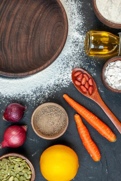 Top view brown wooden plate with vegetables eggs and seasonings on a dark background sugar color cake white tea cookie salad food biscuit