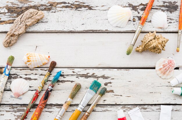 Top view brushes line on white wooden background