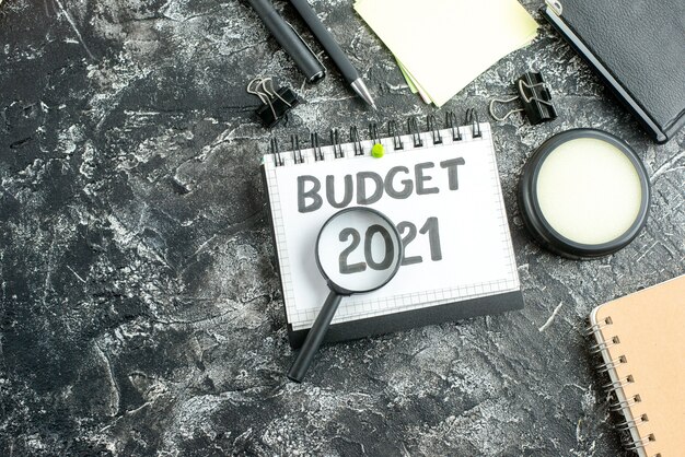 top view budget note with magnifier on dark surface color college student school job bank business