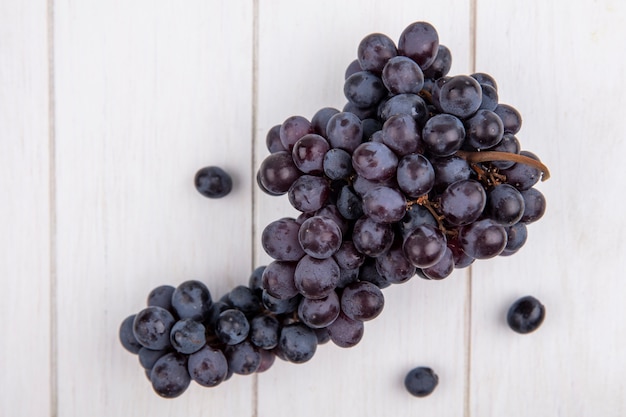 Top view bunch of black grapes on white background