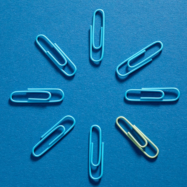 Top view bunch of blue paper clips on the table