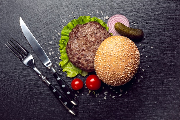 Top view burger ingredients on slate background