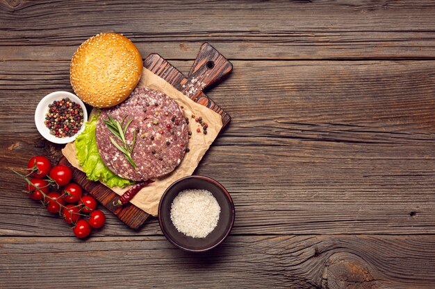 Top view burger ingredients on a wooden table