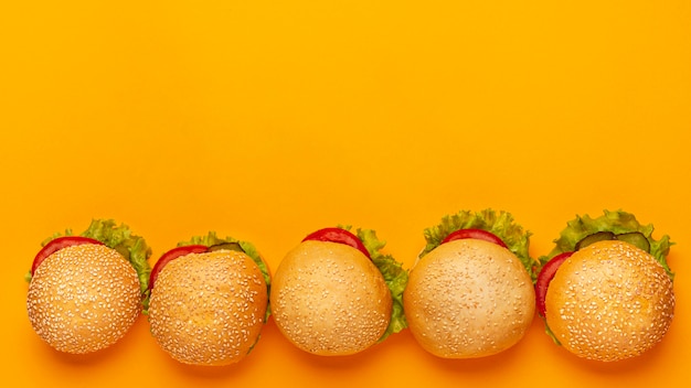 Free photo top view burgers frame with orange background