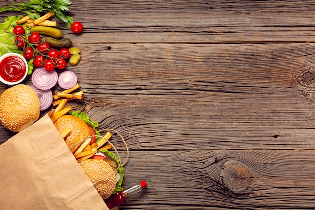 Top view burgers with french fries in a bag