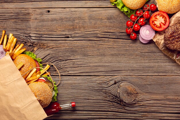 Top view burgers with french fries in a bag