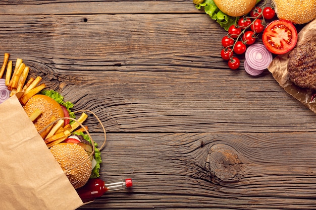 Top view burgers with french fries in a bag