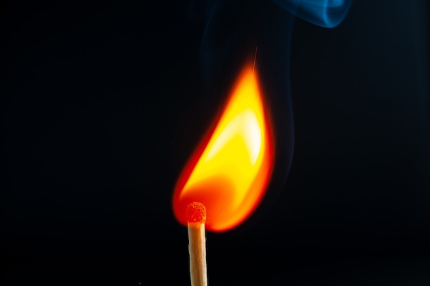 Free photo top view of burning one match lighting ton dark background