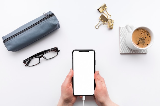 Top view business desk arrangement with empty phone